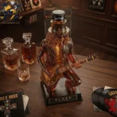 Jack Daniel's Slash Guitar Collector Decanter Bottle 2026 2 Slash limited edition whiskey bottle figurine on a wooden table.