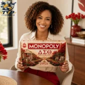 Woman smiling while holding a Delta Sigma Theta Monopoly board game from Tvpcomebackshop.