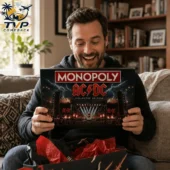 ACDC Band Collector's Edition Monopoly Board Game 2 Man holding AC/DC Monopoly Collector Edition board game at home