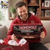 Arkansas Razorbacks Collector's Edition Monopoly Board Game 2026 2 Man holding an Arkansas Razorbacks Monopoly collector edition board game.