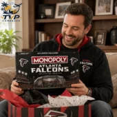 A man holding an Atlanta Falcons Monopoly collector edition board game.