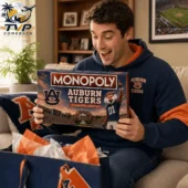 Auburn Tigers Collector's Edition Monopoly Board Game 2026 2 Man holding an Auburn Tigers Monopoly collector edition board game