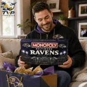 Baltimore Ravens Collector Edition Monopoly Board Game 2 Man holding Baltimore Ravens Monopoly Collector Edition game box