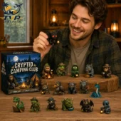 Man holding a small winged creature figure from the Cryptid Camping Club toy collection