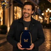 Dolly Parton In Loving Memory Bottle & Velvet Bag 2 Man holding a luxury blue velvet fragrance bag with a gold butterfly emblem by Tvpcomebackshop.