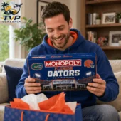 Florida Gators Collector's Edition Monopoly Board Game 2 Man smiling while holding a Florida Gators Monopoly Collector Edition board game