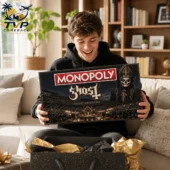 Ghost Band Collector's Edition Monopoly Board Game 2026 1 A young man unboxing a Ghost band themed Monopoly collector edition board game.