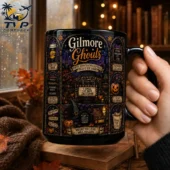 Black ceramic Gilmore Ghouls mug held by a hand