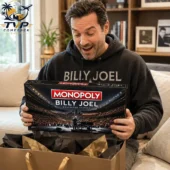 Monopoly Billy Joel Collector's Edition Board Game 2 A man excitedly holding a Billy Joel Monopoly Collector Edition game box.