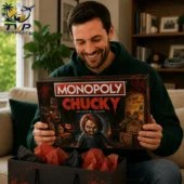 Man smiling while holding a Chucky Collector Edition Monopoly board game from Tvpcomebackshop.