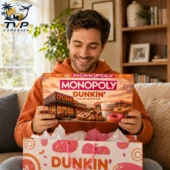 Man holding a Dunkin' Monopoly Collector's Edition game board box