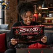Monopoly Georgia Bulldogs Limited Collector's Edition Board Game 2 Woman opening a Georgia Bulldogs Monopoly collector edition game box