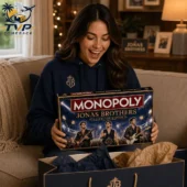 Monopoly Jonas Brothers Collector's Edition Board Game 2 Woman happily holding a Jonas Brothers Monopoly Collector Edition board game.