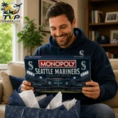 Man holding a Seattle Mariners Monopoly Collector Edition board game