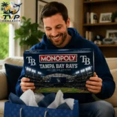 Tampa Bay Rays Collector's Edition Monopoly Board Game 1 A man smiling while holding a Tampa Bay Rays Monopoly Collector Edition game box.