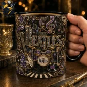 The Beatles Collectible Coffee Mug 1 The Beatles themed black mug with gold and purple musical instruments and ornate decorations