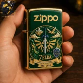 Green Zippo lighter with The Legend of Zelda 40th anniversary design held in a hand