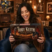 A woman holding a Toby Keith Collector Edition Monopoly board game.
