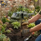 Vietnam Veteran memorial helicopter garden stake held by hands in gardening gloves