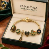 Pandora Bob Marley gold snake chain bracelet with music-themed charms in a presentation box.