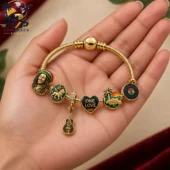 Gold charm bracelet with reggae music and Bob Marley themed charms