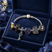 Coraline-themed charm bracelet on a blue velvet background from Tvpcomebackshop