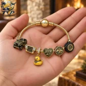 Gold Jeep-themed charm bracelet on a hand