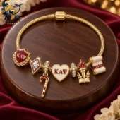 Kappa Alpha Psi gold charm bracelet with commemorative 1911 symbols.