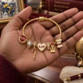 Kappa Alpha Psi gold charm bracelet held in hand