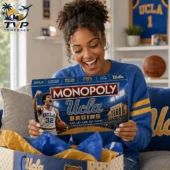 Woman smiling while opening a UCLA Bruins Monopoly collector edition game box