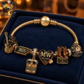 Customized gold charm bracelet featuring country music themed charms in a velvet gift box.