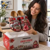 Woman holding customized Ohio State Birkenstock clogs from Tvpcomebackshop