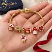 Pandora Sydney Swans themed gold charm bracelet held in hand