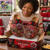 Woman holding custom Texas Tech Red Raiders Birkenstock-inspired clogs with team emblems