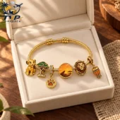 Gold charm bracelet featuring Lion King characters and themed icons